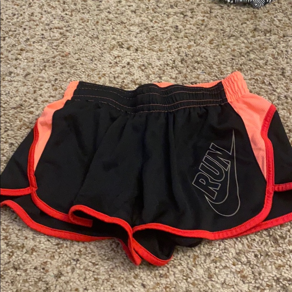Black, light pink, and dark pink nike shorts